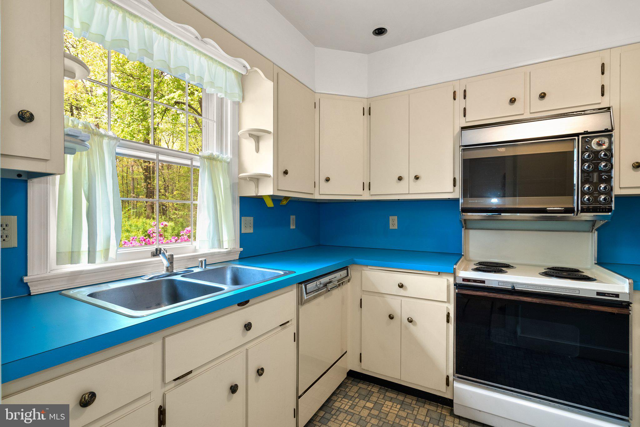 4811 Olney Laytonsville Road Olney, MD 20832 - Photo 25 of 63 a kitchen with stainless steel appliances granite countertop a sink a stove and microwave