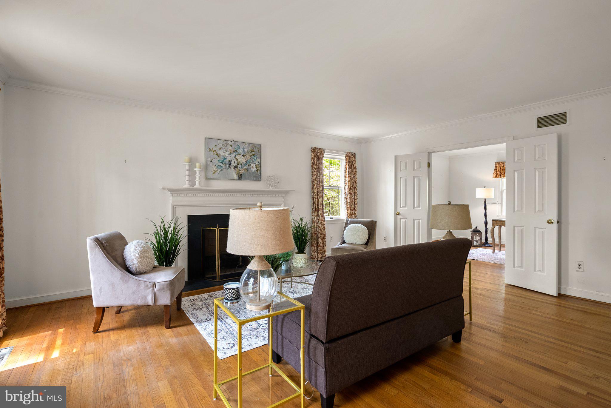 4811 Olney Laytonsville Road Olney, MD 20832 - Photo 3 of 63 a living room with furniture a fireplace and a table
