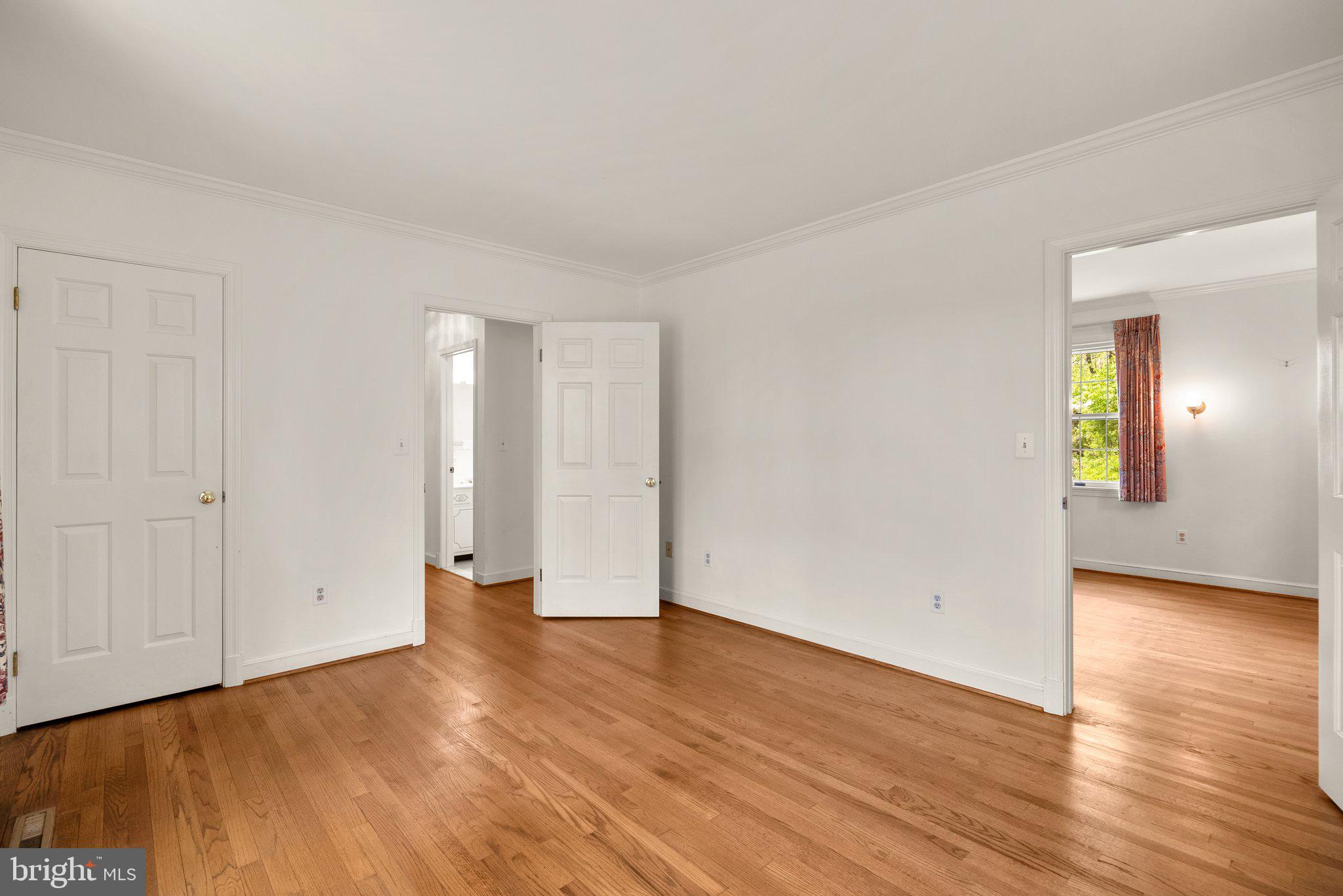 4811 Olney Laytonsville Road Olney, MD 20832 - Photo 31 of 63 a view of an empty room with wooden floor and a window
