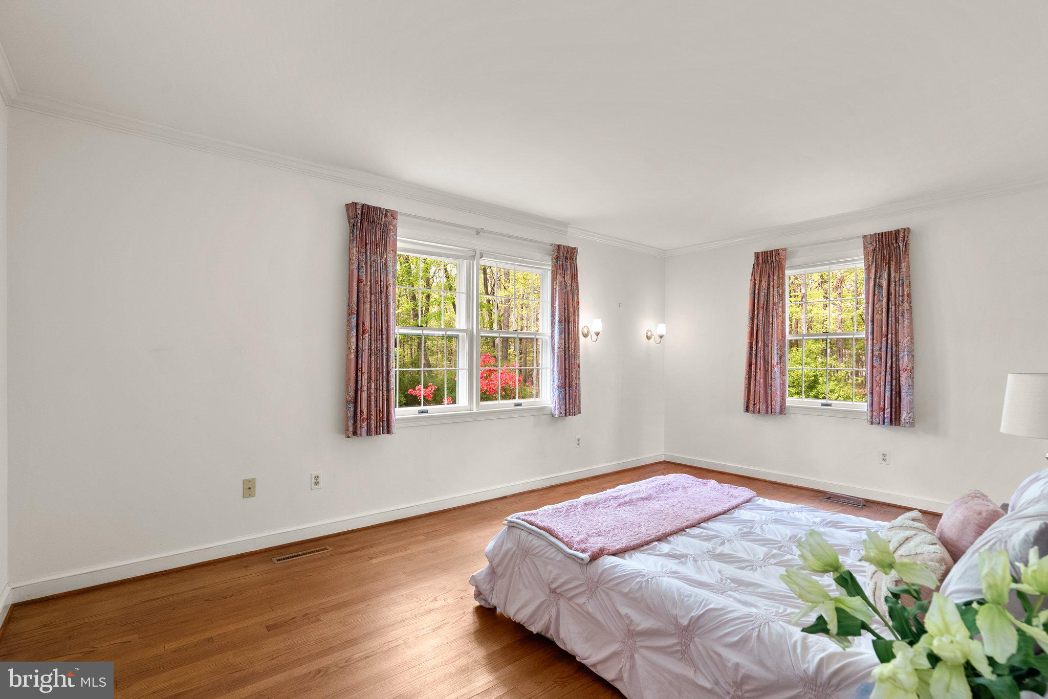 4811 Olney Laytonsville Road Olney, MD 20832 - Photo 32 of 63 a bed sitting in a bedroom next to a window