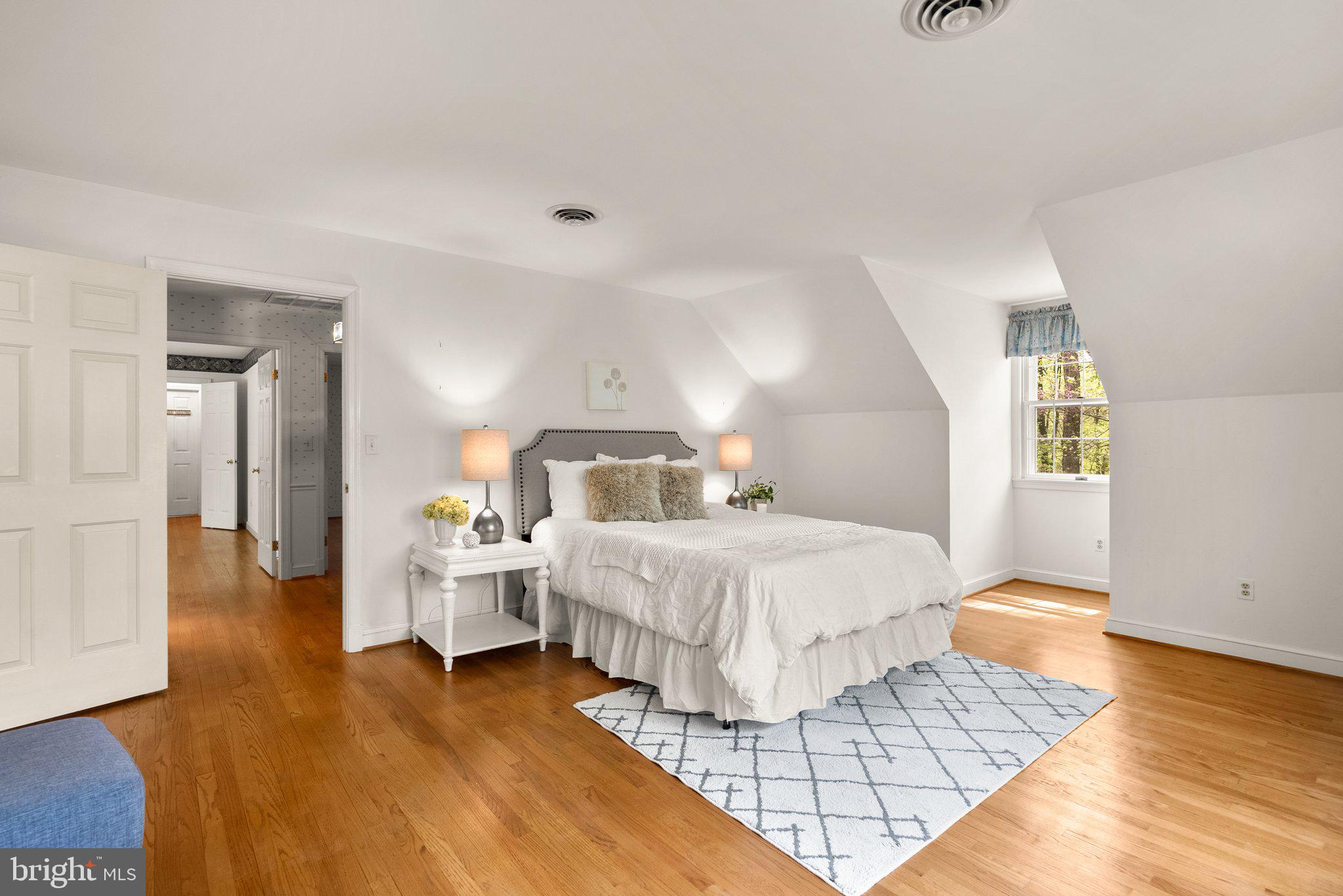 4811 Olney Laytonsville Road Olney, MD 20832 - Photo 37 of 63 a bedroom with a bed and wooden floor