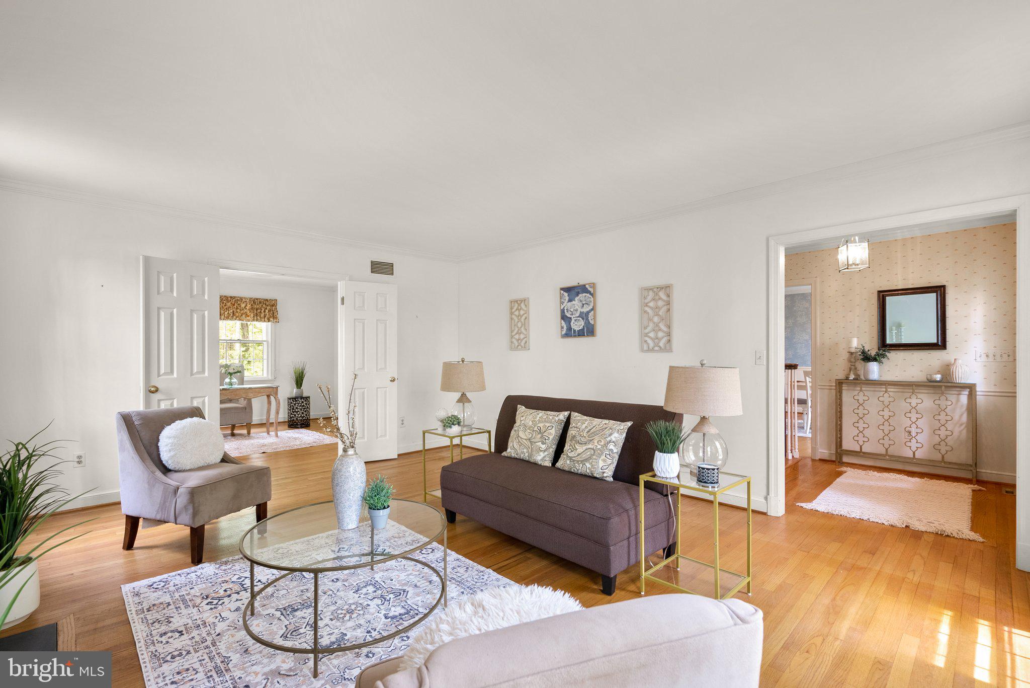 4811 Olney Laytonsville Road Olney, MD 20832 - Photo 4 of 63 a living room with furniture and a wooden floor