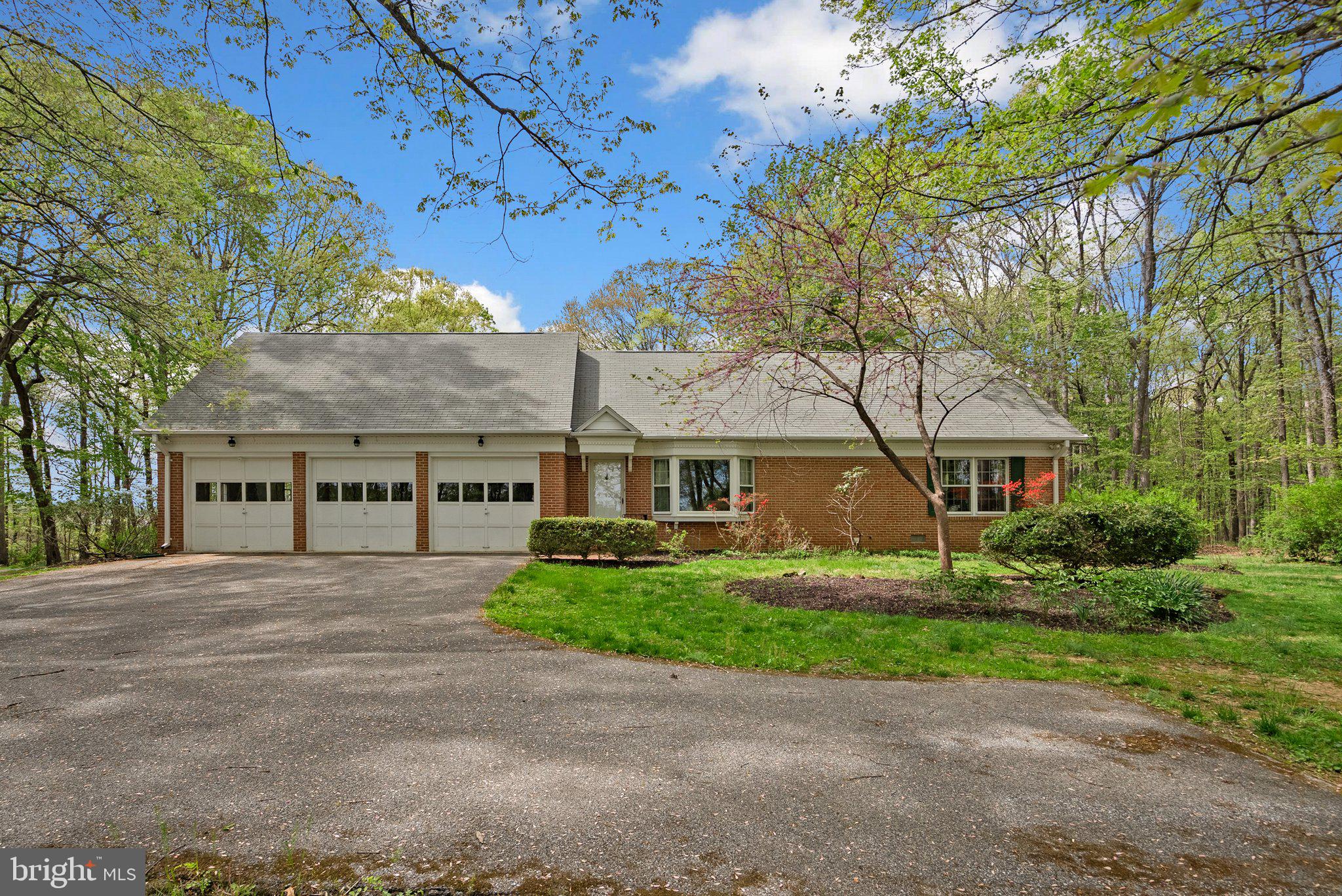 4811 Olney Laytonsville Road Olney, MD 20832 - Photo 56 of 63 a front view of a house with a garden and trees