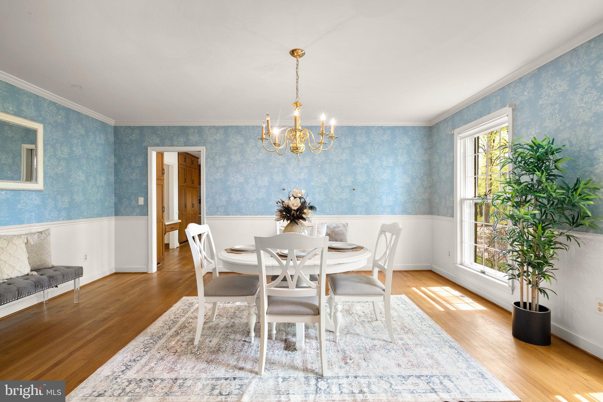 4811 Olney Laytonsville Road Olney, MD 20832 - Photo 8 of 63 a dining room with wooden floor a chandelier a wooden table and chairs