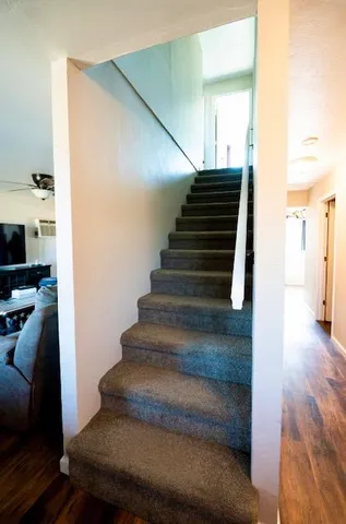 a view of entryway and hall with wooden floor