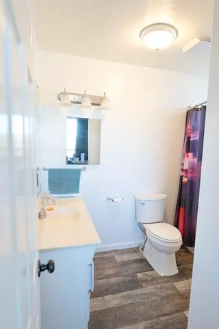 a bathroom with a sink toilet and a mirror