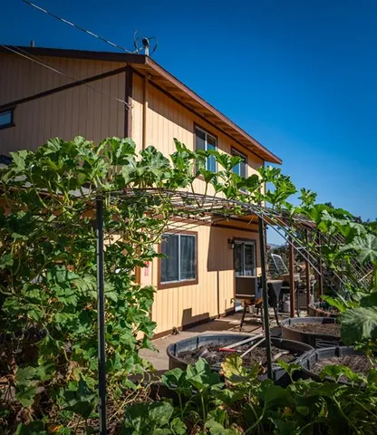 a front view of a house with garden