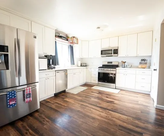 a kitchen with stainless steel appliances a refrigerator sink and microwave