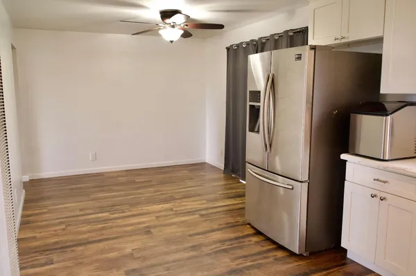 a metallic refrigerator freezer sitting in a kitchen