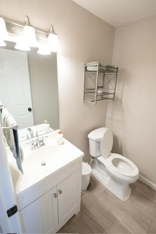 a bathroom with a sink a toilet and mirror