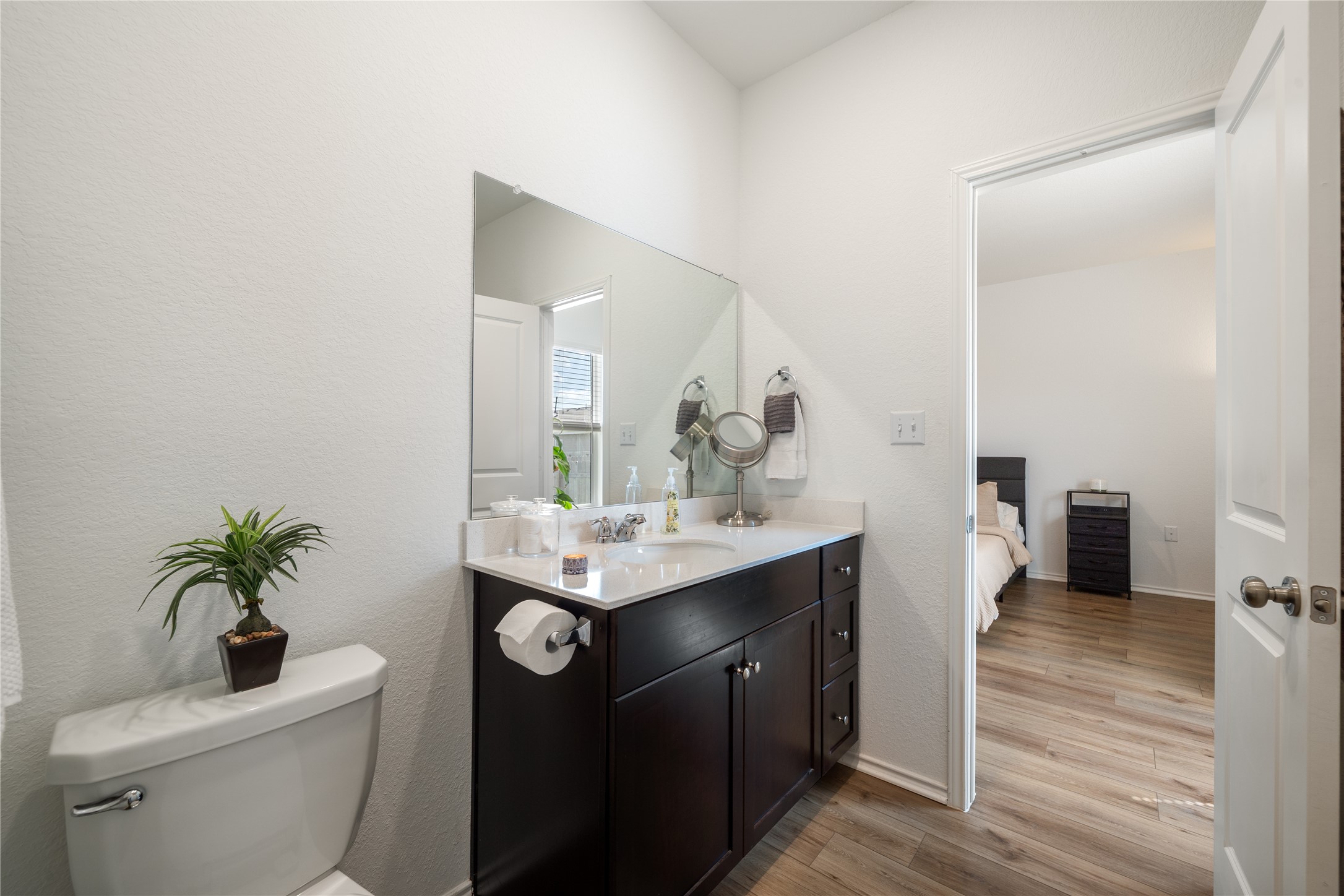 14404 Berning Road Manor, TX 78653 - Photo 20 of 38 A well-appointed bathroom with vanity and toilet, providing convenient access to a secondary bedroom.