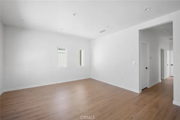 a view of a room with wooden floor