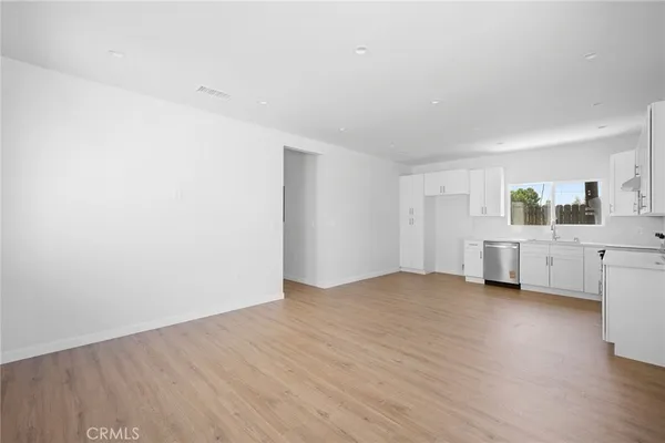 a view of a room with wooden floor and window