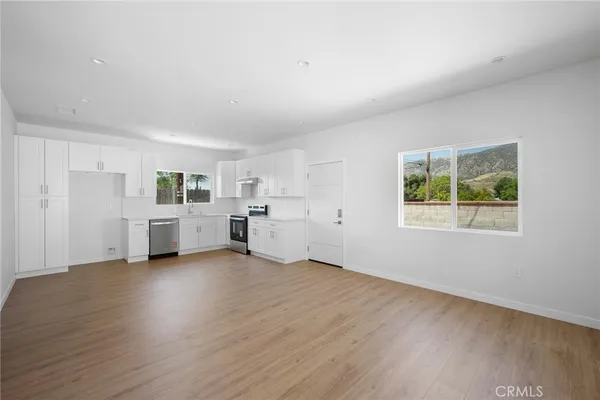 a view of a room with wooden floor and white walls