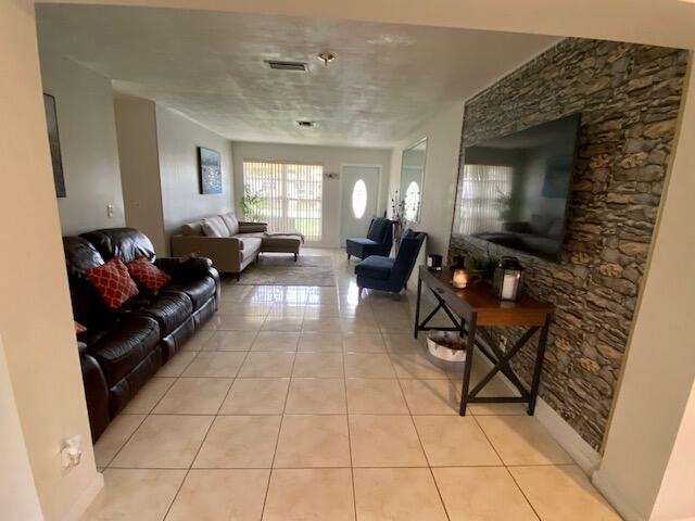 324 Winged Foot Road Palm Springs, FL 33461 - Photo 2 of 12 LIVING ROOM & FAMILY