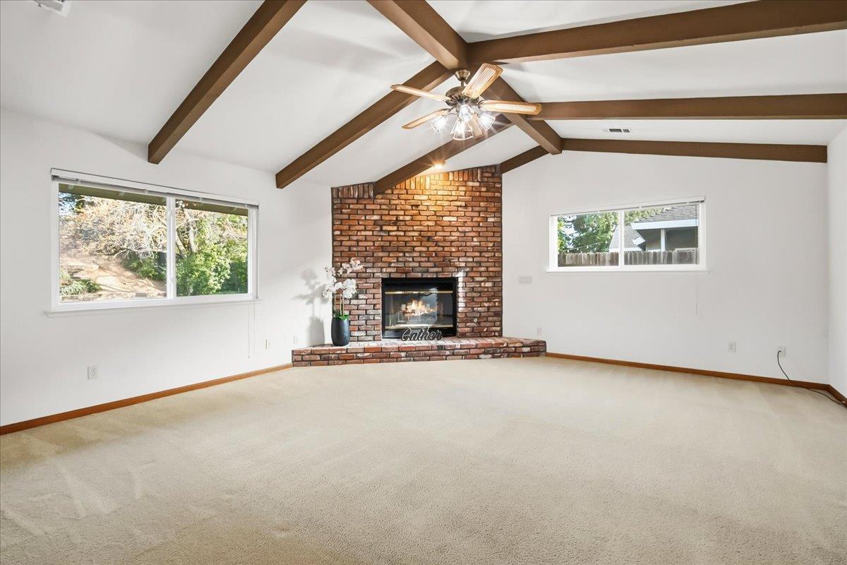 363 Diamond Oaks Road Roseville, CA 95678 - Photo 14 of 51 A separate family room featuring a raised hearth fireplace and wood beams creates a classic, cozy atmosphere that anchors the home for gatherings.