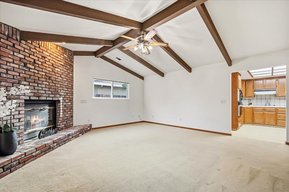 363 Diamond Oaks Road Roseville, CA 95678 - Photo 15 of 51 A separate family room featuring a raised hearth fireplace and wood beams creates a classic, cozy atmosphere that anchors the home for gatherings. Located next to the kitchen.