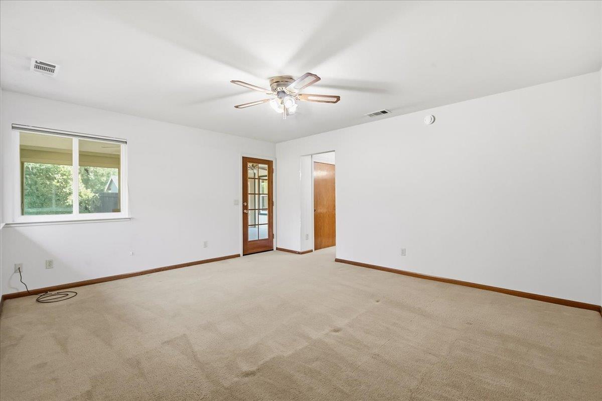 363 Diamond Oaks Road Roseville, CA 95678 - Photo 23 of 51 Experience unmatched utility and light in this primary ensuite retreat, complete with twin closets and a dedicated portal to your backyard oasis. View of door to enclosed patio and doorway to closets and ensuite bathroom.