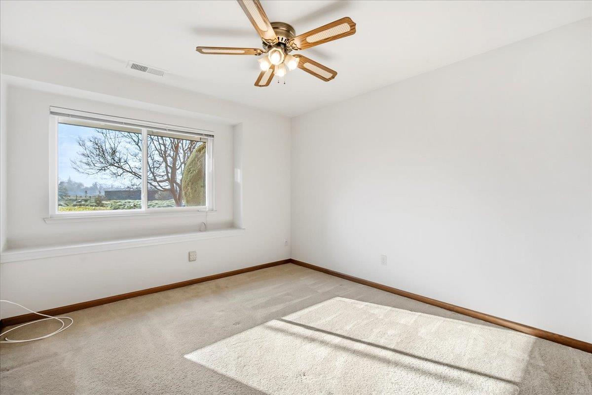 363 Diamond Oaks Road Roseville, CA 95678 - Photo 28 of 51 This charming front bedroom boasts a bespoke built-in ledge, creating a perfect sanctuary for reading and seamless indoor-outdoor viewing.