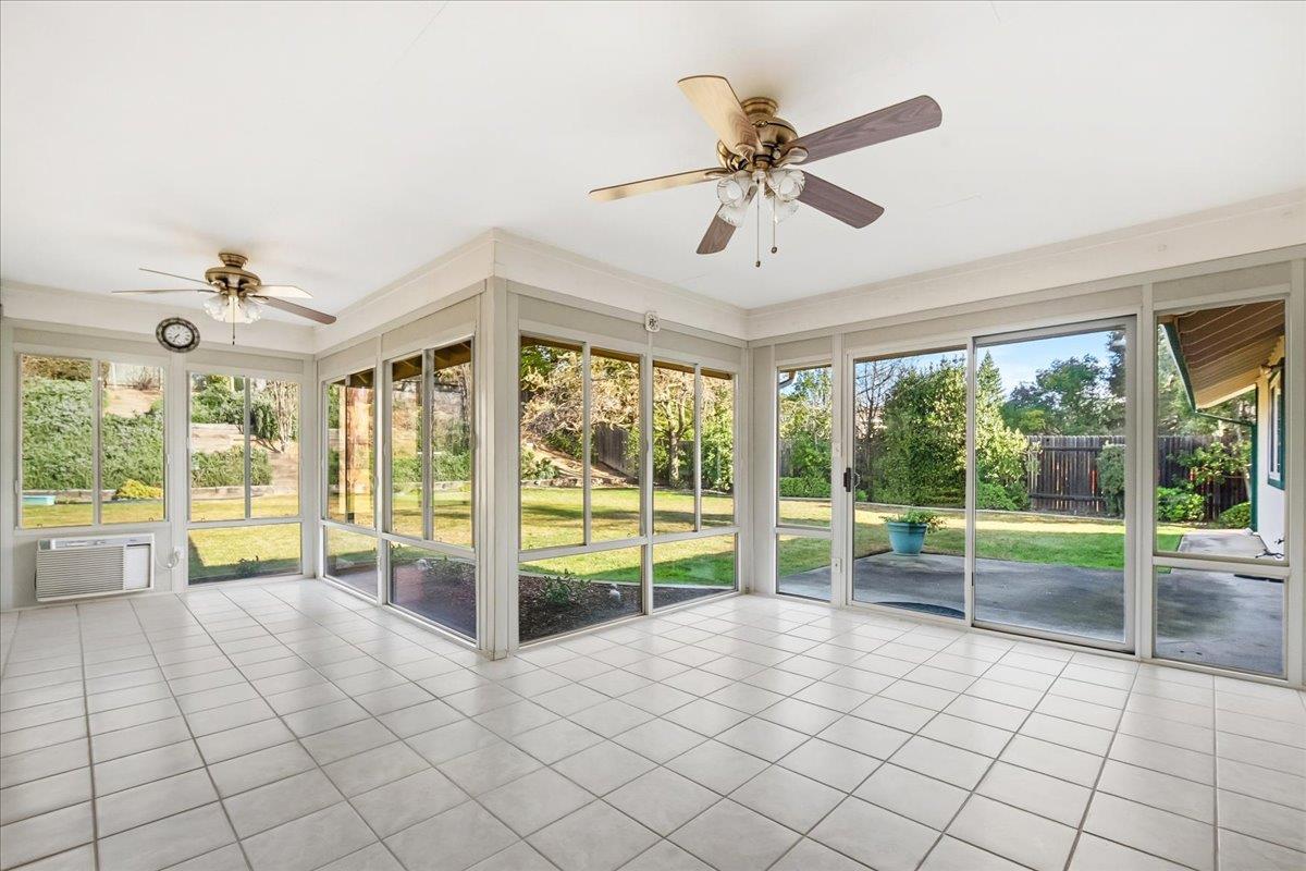 363 Diamond Oaks Road Roseville, CA 95678 - Photo 36 of 51 Rain or shine...A fluid transition space: this expansive enclosed patio features private portals to the primary suite, the main living area, and the backyard.