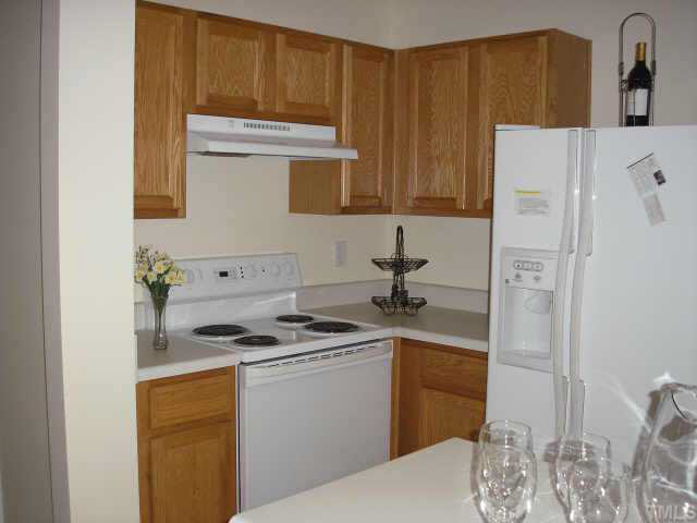 5704 Bryanstone Place Raleigh, NC 27610 - Photo 4 of 10 a kitchen with a sink stove and refrigerator