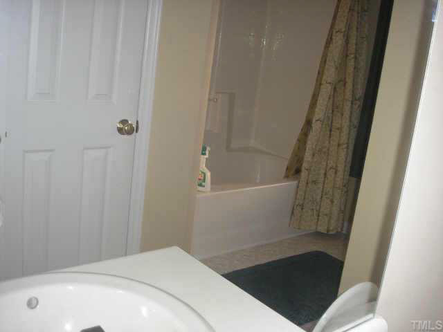 5704 Bryanstone Place Raleigh, NC 27610 - Photo 6 of 10 a bathroom with a tub and shower