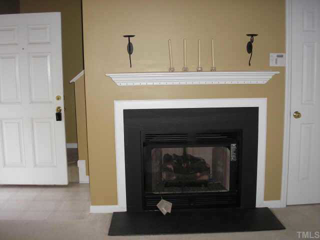 5704 Bryanstone Place Raleigh, NC 27610 - Photo 8 of 10 a living room with a fireplace in it