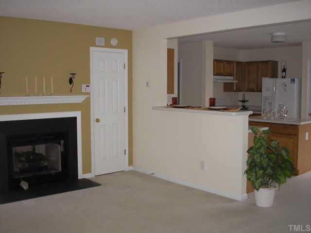 5704 Bryanstone Place Raleigh, NC 27610 - Photo 9 of 10 a kitchen with a sink and a fireplace