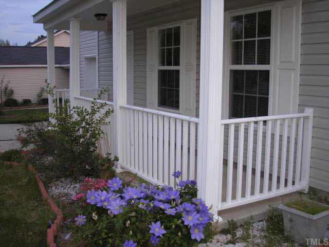 5704 Bryanstone Place Raleigh, NC 27610 - Photo 10 of 10 a house with a flower garden in front of it