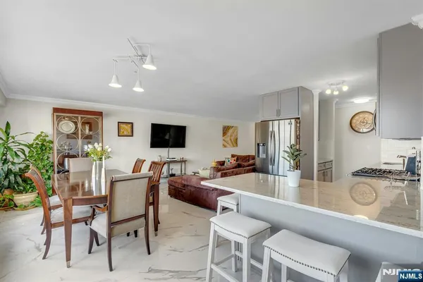 a kitchen with stainless steel appliances granite countertop a refrigerator and a stove top oven