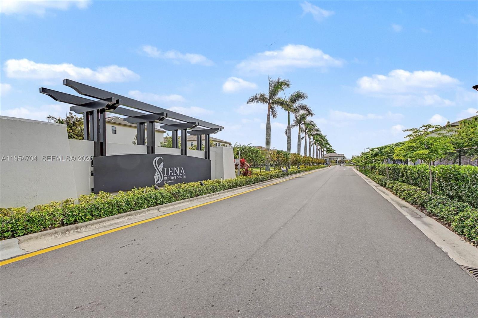 a front view of a house with a yard and garden