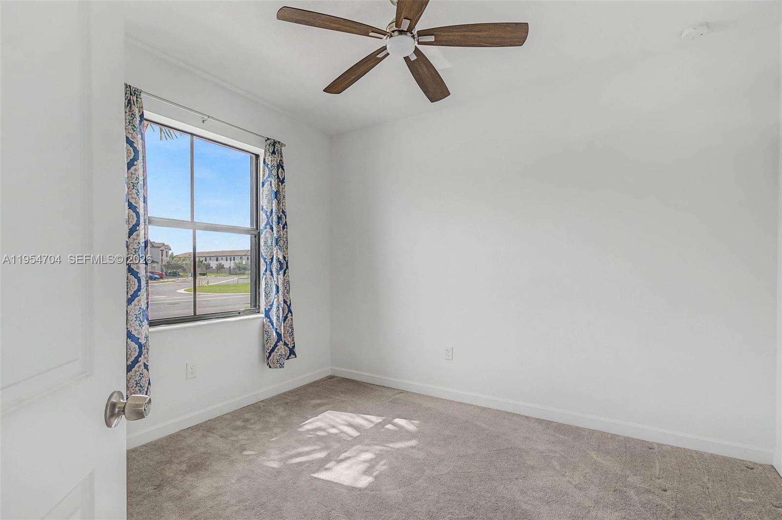 12947 Southwest 234th Street Homestead, FL 33032 - Photo 12 of 33 a view of an empty room and window