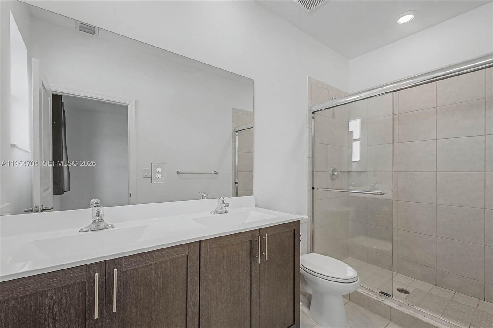 12947 Southwest 234th Street Homestead, FL 33032 - Photo 14 of 33 a bathroom with a sink a toilet and shower