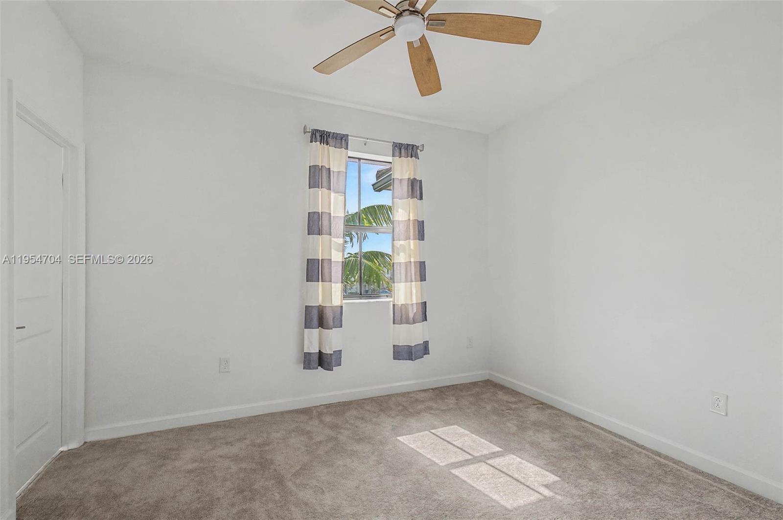12947 Southwest 234th Street Homestead, FL 33032 - Photo 18 of 33 an empty room with windows and fan