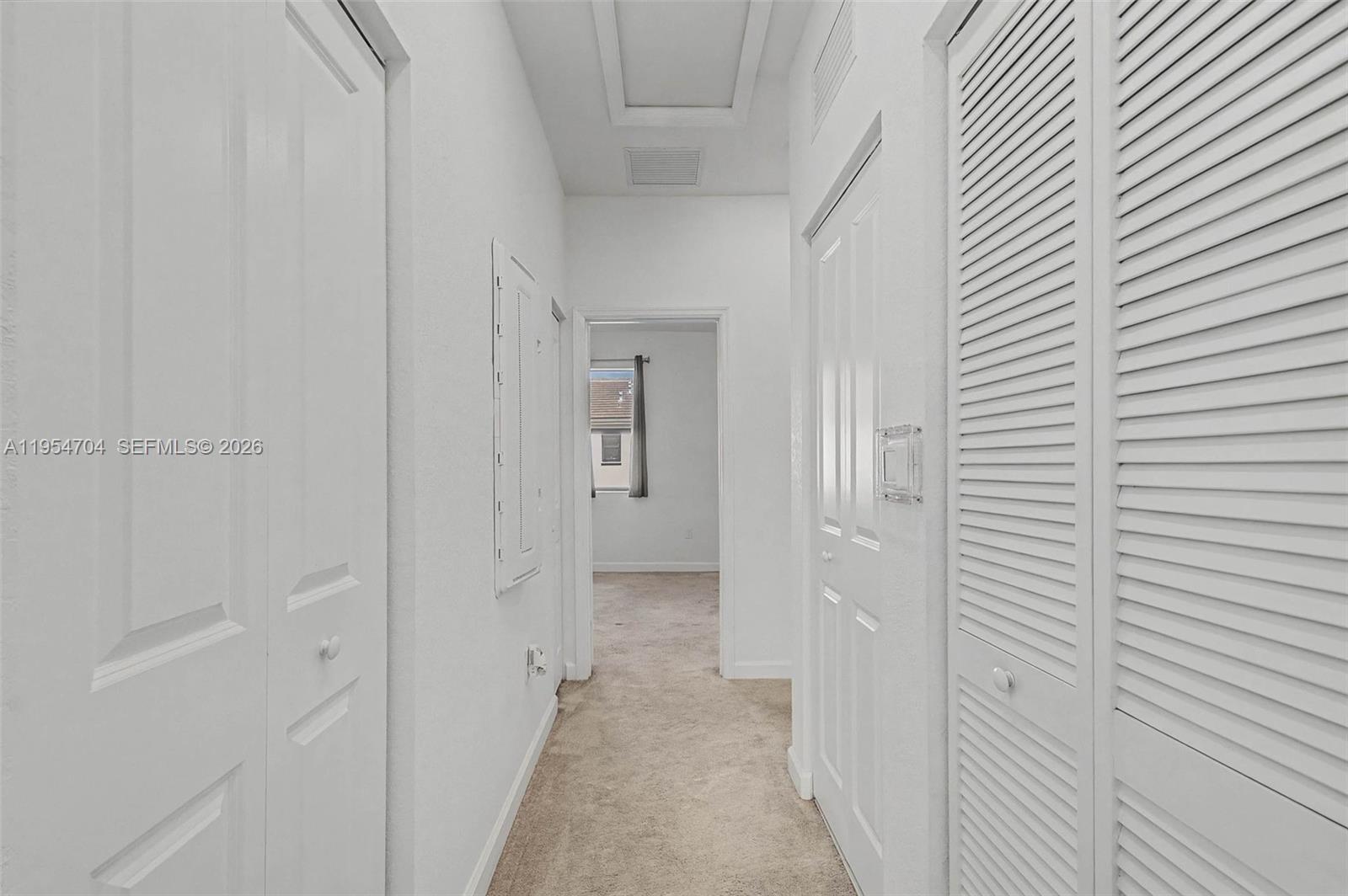 12947 Southwest 234th Street Homestead, FL 33032 - Photo 20 of 33 a view of a hallway with a white wooden cabinets