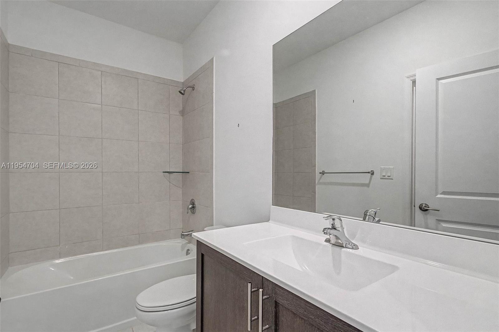 12947 Southwest 234th Street Homestead, FL 33032 - Photo 21 of 33 a bathroom with a granite countertop sink toilet and shower