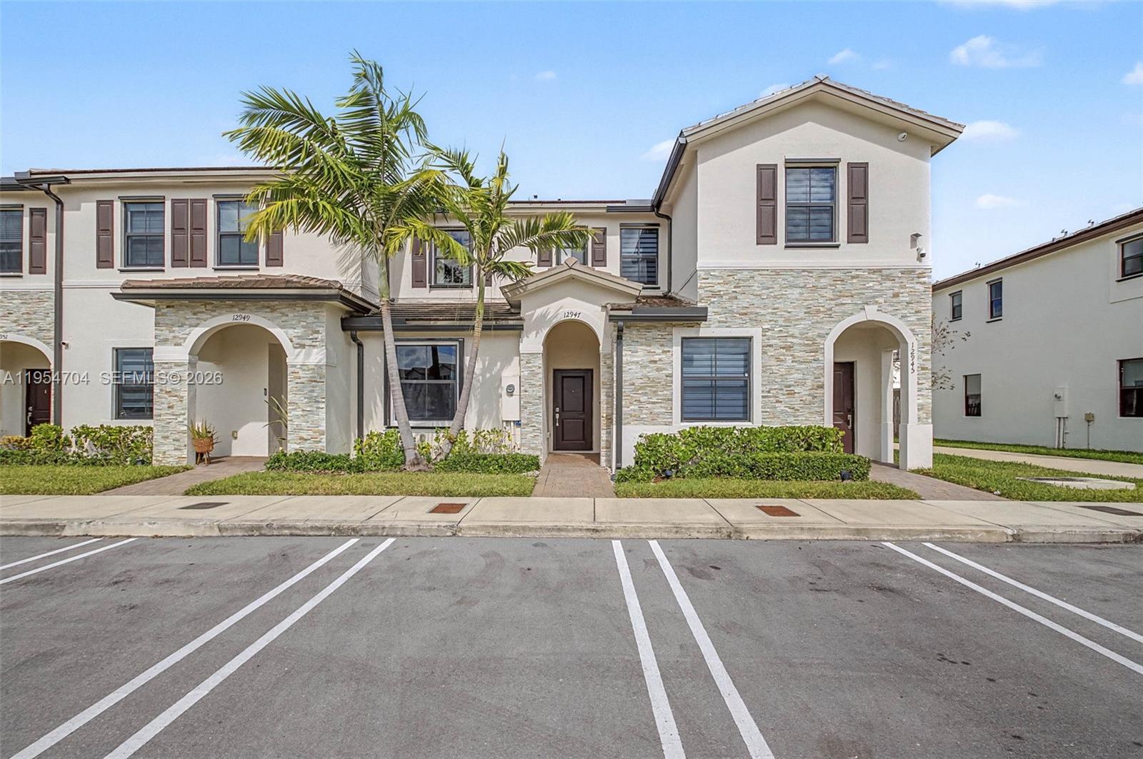 12947 Southwest 234th Street Homestead, FL 33032 - Photo 5 of 33 a front view of a house with a yard and garage