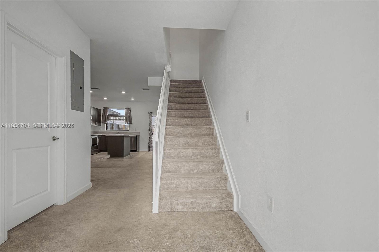 12947 Southwest 234th Street Homestead, FL 33032 - Photo 6 of 33 a view of a hallway with wooden floor and staircase