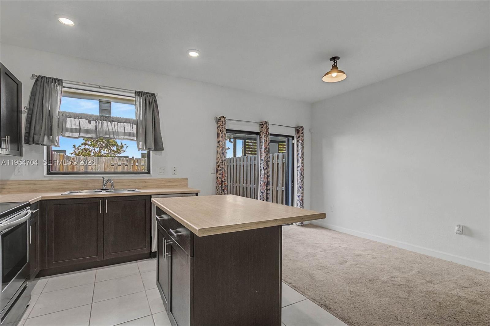 12947 Southwest 234th Street Homestead, FL 33032 - Photo 9 of 33 a kitchen with a sink and cabinets