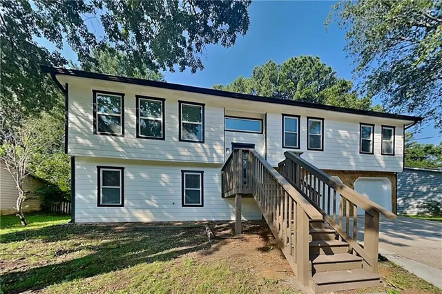 a front view of house with yard and green space