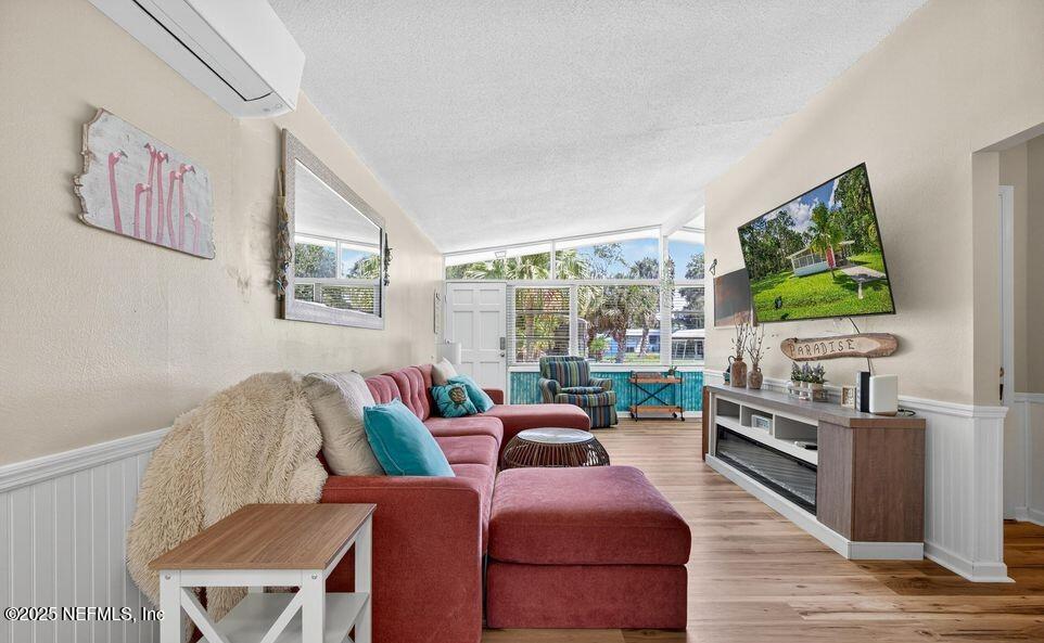 119 Ludwig Avenue Crescent City, FL 32112 - Photo 11 of 31 a living room with furniture a flat screen tv and a floor to ceiling window