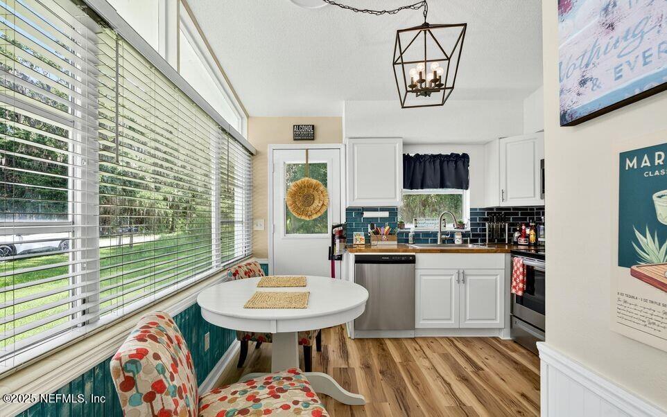 119 Ludwig Avenue Crescent City, FL 32112 - Photo 12 of 31 a kitchen with stainless steel appliances a sink a table and chairs