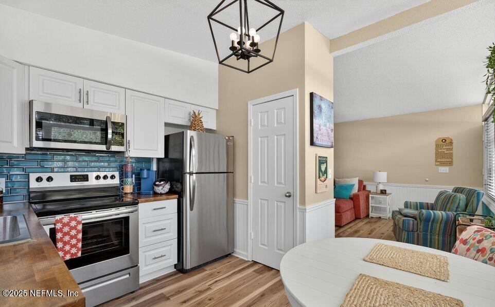 119 Ludwig Avenue Crescent City, FL 32112 - Photo 16 of 31 a kitchen with stainless steel appliances a stove a refrigerator and cabinets
