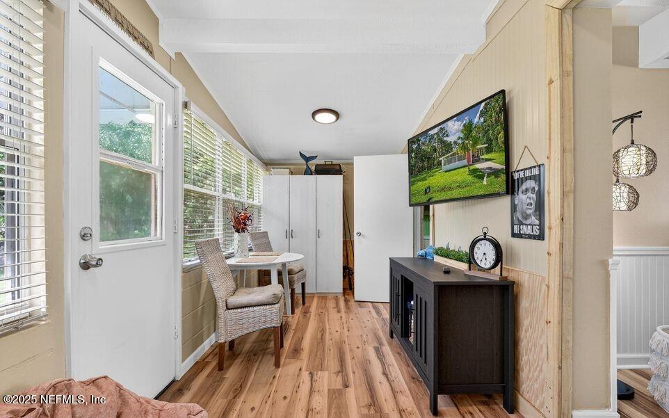 119 Ludwig Avenue Crescent City, FL 32112 - Photo 19 of 31 a living room with furniture a flat screen tv and a floor to ceiling window