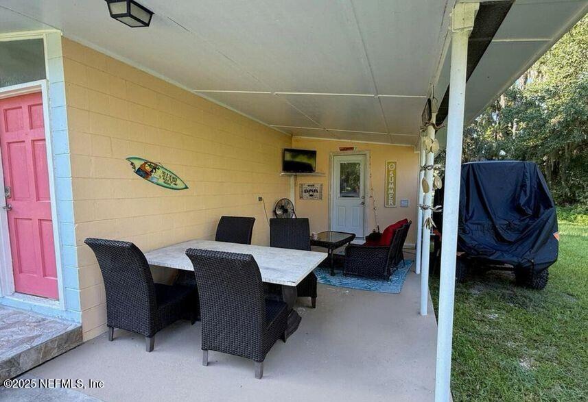 119 Ludwig Avenue Crescent City, FL 32112 - Photo 23 of 31 a living room with furniture rug and outdoor view
