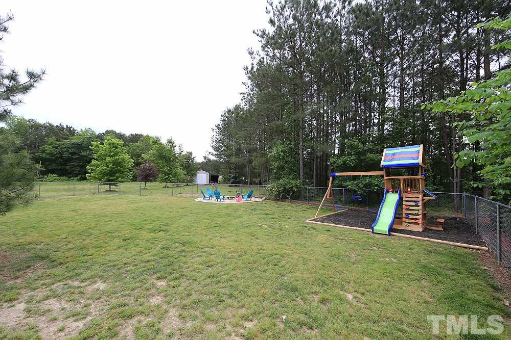 706 Perry Curtis Road Zebulon, NC 27597 - Photo 16 of 19 Large fenced in yard with New play set, and New fire pit.
