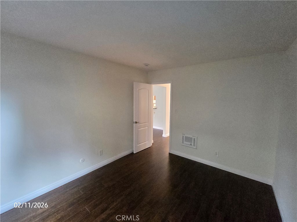 1345 Cabrillo Park, Unit R03 Santa Ana, CA 92701 - Photo 11 of 21 a view of an empty room and a hard wood floor