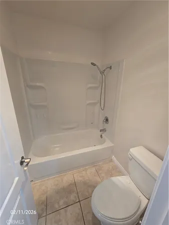 a bathroom with a toilet and a bath tub