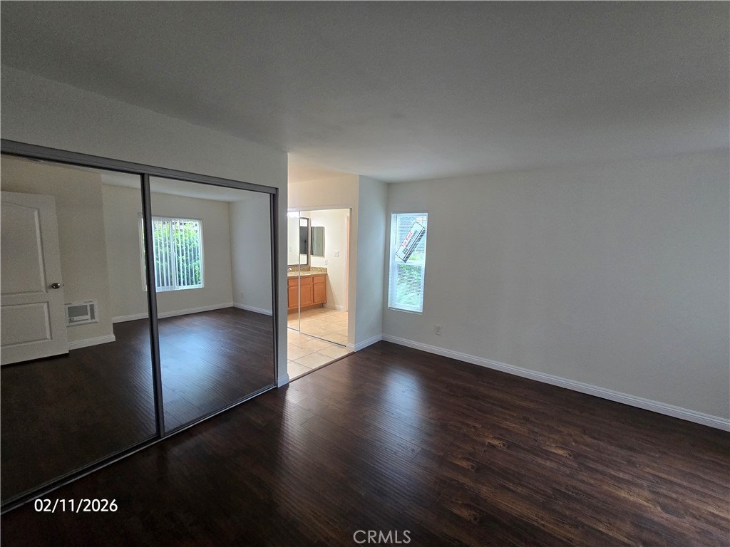1345 Cabrillo Park, Unit R03 Santa Ana, CA 92701 - Photo 15 of 21 an empty room with wooden floor and windows