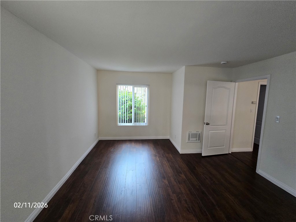 1345 Cabrillo Park, Unit R03 Santa Ana, CA 92701 - Photo 16 of 21 an empty room with wooden floor and window